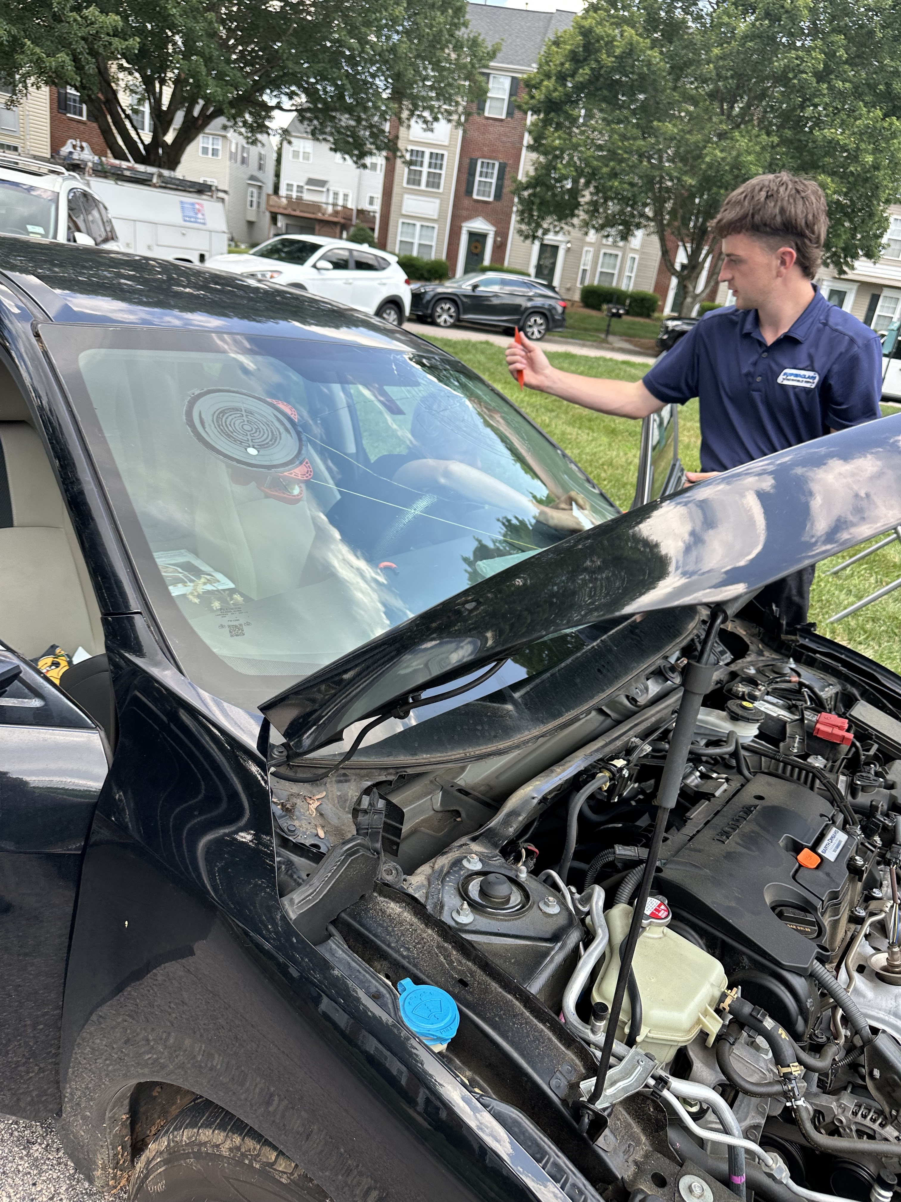 SuperGlass certified technician windshield repair on black SUV Charlotte NC